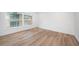 Spacious bedroom featuring wood-look floors and large windows at 2156 Masters Ct # 2156, Dunedin, FL 34698