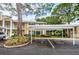 Condo building with covered parking and landscaping at 2156 Masters Ct # 2156, Dunedin, FL 34698