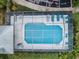 Aerial view of community pool with screened enclosure and lounge chairs at 2156 Masters Ct # 2156, Dunedin, FL 34698