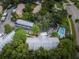 Community overview showcasing lush landscaping and a sparkling pool at 2156 Masters Ct # 2156, Dunedin, FL 34698