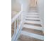 Modern staircase with wood-look treads and white risers at 2156 Masters Ct # 2156, Dunedin, FL 34698
