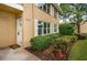 Condo building exterior with landscaping and entrance at 2156 Masters Ct # 2156, Dunedin, FL 34698