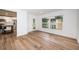 Bright dining area with wood-look floors and kitchen view at 2156 Masters Ct # 2156, Dunedin, FL 34698