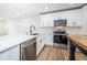 Modern white kitchen with stainless steel appliances at 2156 Masters Ct # 2156, Dunedin, FL 34698
