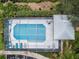 Aerial view of community pool with screened enclosure and lounge chairs at 2156 Masters Ct # 2156, Dunedin, FL 34698