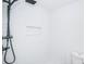 Clean shower with white wave tile and black fixtures at 2156 Masters Ct # 2156, Dunedin, FL 34698