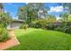 Backyard with a brick walkway, green lawn and shed at 768 Pinellas Point S Dr, St Petersburg, FL 33705