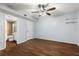 Bright bedroom with wood-look floors, ceiling fan, and en-suite bathroom at 1429 Monte Lake Dr, Valrico, FL 33596