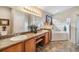 Bathroom with double vanity, soaking tub, and shower at 13235 Meadow Golf Ave, Hudson, FL 34669