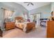 Main bedroom with wood furniture, patio access, and ceiling fan at 13235 Meadow Golf Ave, Hudson, FL 34669