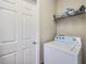 Bright laundry room with washer, dryer, and storage at 13235 Meadow Golf Ave, Hudson, FL 34669