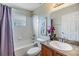 Clean bathroom with tub shower and granite countertop at 13235 Meadow Golf Ave, Hudson, FL 34669