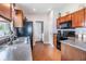 Kitchen with wood cabinets, black appliances, and granite countertops at 13235 Meadow Golf Ave, Hudson, FL 34669