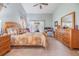 Main bedroom with wood furniture, patio access, and ceiling fan at 13235 Meadow Golf Ave, Hudson, FL 34669