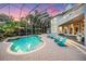 Inviting pool area with a screened enclosure and comfortable seating at 3798 Presidential Dr, Palm Harbor, FL 34685