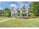 Front view of a two-story house with a landscaped yard and a walkway leading to the entrance at 3798 Presidential Dr, Palm Harbor, FL 34685