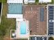 An aerial view of the community clubhouse, pool, shuffleboard, solar panels and parking lot at 12501 Ulmerton Rd # 131, Largo, FL 33774