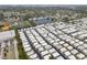 An aerial view displays an expansive mobile home community set alongside a sports field and lake at 12501 Ulmerton Rd # 131, Largo, FL 33774