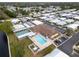 An aerial view shows the community clubhouse, pool and shuffleboard courts among mobile homes at 12501 Ulmerton Rd # 131, Largo, FL 33774