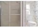 Bathroom with a white toilet and a modern glass shower stall at 12501 Ulmerton Rd # 131, Largo, FL 33774