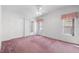 Bright bedroom featuring a ceiling fan, window, and closet for ample storage at 12501 Ulmerton Rd # 131, Largo, FL 33774