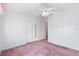 Simple bedroom featuring plush carpeting, closet space, and access to other rooms at 12501 Ulmerton Rd # 131, Largo, FL 33774