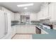 Charming kitchen with white cabinets, a pass-through window, and modern appliances at 12501 Ulmerton Rd # 131, Largo, FL 33774