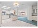 Bright kitchen with white cabinets, updated appliances, and an eat-in bar area at 12501 Ulmerton Rd # 131, Largo, FL 33774
