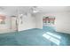 Open floor plan with blue carpet, neutral walls, and bright, natural light throughout at 12501 Ulmerton Rd # 131, Largo, FL 33774