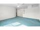 Bright living room with blue carpet, neutral walls, and an open floor plan at 12501 Ulmerton Rd # 131, Largo, FL 33774