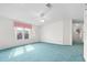 Comfortable primary bedroom featuring neutral walls, blue carpet, and ample natural light at 12501 Ulmerton Rd # 131, Largo, FL 33774