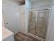 Bathroom with shower and linen storage at 291 Tarpon Ln, Oldsmar, FL 34677