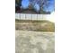Empty lot with a white vinyl fence and a small building in the background at 8114 N Edison Ave, Tampa, FL 33604