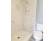 Updated bathroom with marble-look shower and tile flooring at 8114 N Edison Ave, Tampa, FL 33604