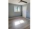 Bright bedroom with wood-look flooring and double doors at 8114 N Edison Ave, Tampa, FL 33604