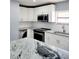 Modern kitchen with white cabinets and granite countertops at 8114 N Edison Ave, Tampa, FL 33604