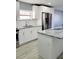 Modern kitchen with white cabinets and granite island at 8114 N Edison Ave, Tampa, FL 33604
