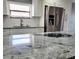Modern kitchen with white cabinets and granite countertops at 8114 N Edison Ave, Tampa, FL 33604