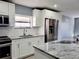 Modern kitchen with stainless steel appliances and granite countertops at 8114 N Edison Ave, Tampa, FL 33604