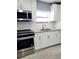 Updated kitchen featuring white cabinets and granite countertops at 8114 N Edison Ave, Tampa, FL 33604