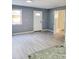 Bright living room with light gray walls and wood-look flooring at 8114 N Edison Ave, Tampa, FL 33604