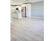 Living room with kitchen view and luxury vinyl plank flooring at 8114 N Edison Ave, Tampa, FL 33604