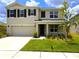 Charming two-story home featuring a well-manicured lawn, attached two-car garage, and a welcoming front porch at 8367 Ender Hills Dr, Wesley Chapel, FL 33545