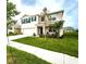 Beautiful home featuring a two-car garage, manicured lawn, and inviting front porch, all viewed from the street at 8367 Ender Hills Dr, Wesley Chapel, FL 33545