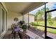Relaxing screened porch with patio furniture, overlooking the backyard at 16005 Cape Coral Dr, Wimauma, FL 33598