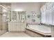 Elegant bathroom with corner soaking tub, granite countertops, and walk-in shower at 16005 Cape Coral Dr, Wimauma, FL 33598