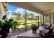 Relaxing screened porch with brick flooring and comfortable seating at 16005 Cape Coral Dr, Wimauma, FL 33598