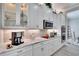 Modern kitchen with white cabinets, granite countertops, and stainless steel appliances at 16005 Cape Coral Dr, Wimauma, FL 33598