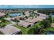 Aerial view of a residential area with houses and a lake at 16005 Cape Coral Dr, Wimauma, FL 33598