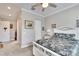 Bedroom with white dresser, ceiling fan, and large windows at 16005 Cape Coral Dr, Wimauma, FL 33598